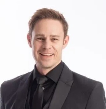 Man in formal suit smiling