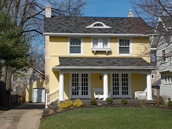 We buy houses representation—pretty house in MA in yellow and white paint
