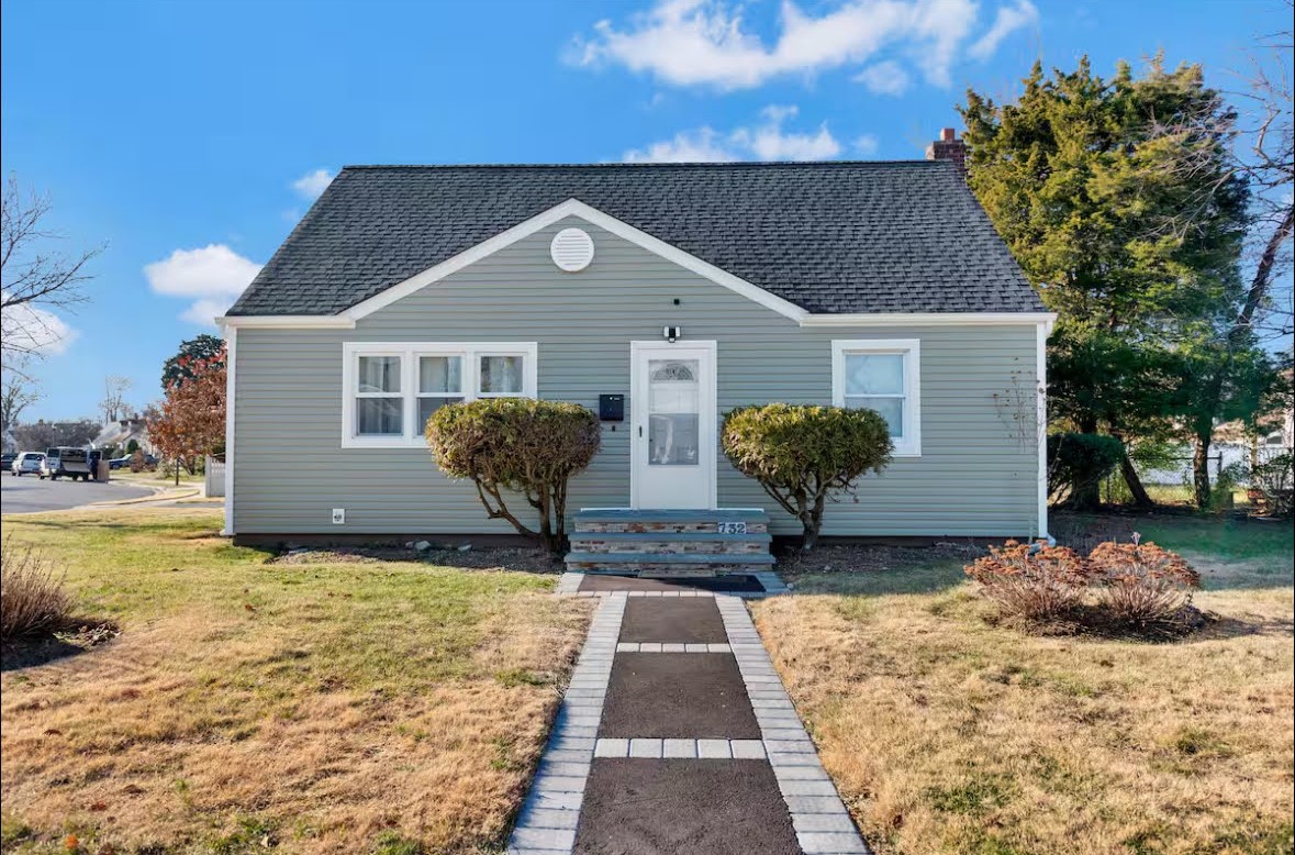 A pretty home in gray with stairs and windows painted in white